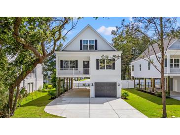 Charming two-story coastal home with a driveway and a garage underneath the main level at 1718 26Th Ave. N, North Myrtle Beach, SC 29582