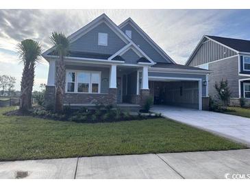 Charming single-Gathering home with brick accents, a well-manicured lawn, and an attached carport at 2256 Vera Way, Longs, SC 29568