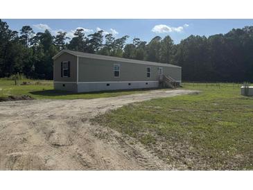 Exterior view of single Gathering home featuring modern siding and a spacious front yard at 364 Jamie Rd., Galivants Ferry, SC 29544