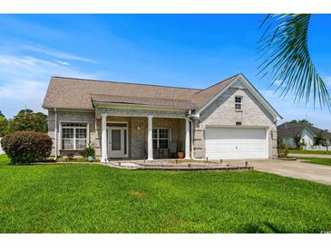 Charming single-story home with a well-manicured lawn and attached two-car garage at 4162 Dupree Dr., Little River, SC 29566