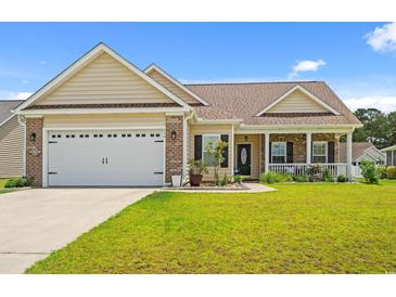 Charming single-story home featuring a two-car garage, inviting front porch, and manicured lawn at 716 Weston Dr., Conway, SC 29526