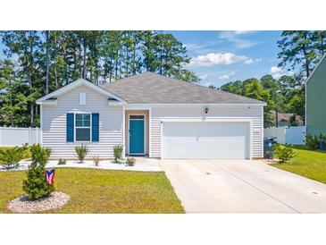 Charming single-story home featuring a teal front door, blue shutters, and a well-manicured lawn at 1074 Sennema Circle, Myrtle Beach, SC 29588