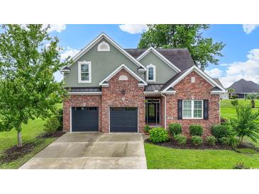 Charming two-story brick home featuring a two-car garage and manicured landscaping at 1106 Bluffton Ct., Myrtle Beach, SC 29579