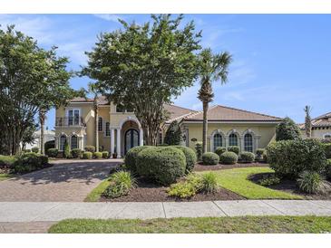 Stunning two-story home with a well-manicured lawn, mature trees, and a brick driveway at 1503 Cadiz Dr., Myrtle Beach, SC 29579