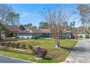 Well-maintained single-story home featuring a lush front lawn, tidy landscaping, and a classic mailbox at 1546 Bay Tree Ln., Myrtle Beach, SC 29575