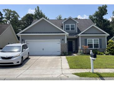 Charming single-Gathering home with a well-maintained front lawn and attached two-car garage at 340 Barony Dr., Conway, SC 29526