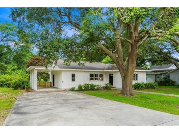 Charming single-story home with covered parking, mature trees, and well-maintained landscaping at 4325 Ellis Ave., Little River, SC 29566