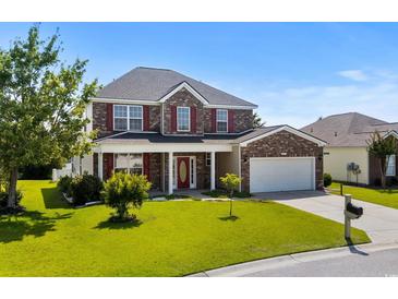Charming two-story brick home featuring a well-manicured lawn and an attached two-car garage at 445 Mooreland Dr., Myrtle Beach, SC 29588
