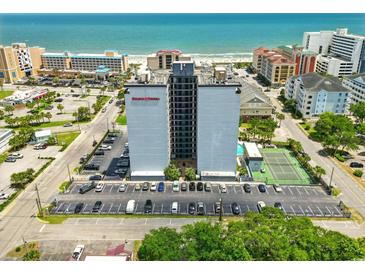 A scenic aerial view of Holiday Towers apartments near the beach showing parking and nearby amenities at 601 Mitchell Dr. # 607, Myrtle Beach, SC 29577