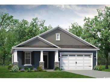 Charming single-story home boasts a two-car garage, covered porch, and attractive landscaping at 628 Millbrook Way, Loris, SC 29569