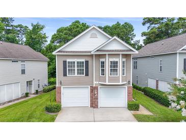 Charming home with a two-car garage and well-maintained lawn at 670 2Nd Ave. N, North Myrtle Beach, SC 29582