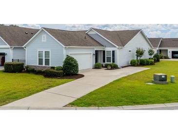 Charming home with well-maintained lawn, neutral siding, dark shutters, and concrete driveway at 754 Salerno Circle # F, Myrtle Beach, SC 29579