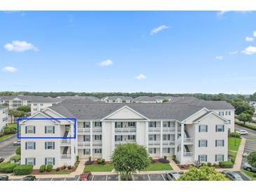 Exterior view of condo building featuring a white facade, balconies and neatly landscaped surroundings at 901 W Port Dr. # 2114, North Myrtle Beach, SC 29582