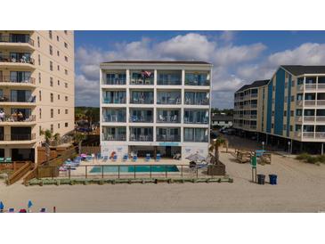 Oceanfront condo building featuring multiple balconies and a shared pool at 920 N Waccamaw Dr. # 2310, Murrells Inlet, SC 29576
