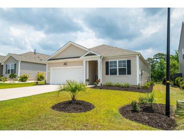 Charming single-story home with manicured lawn, neutral siding, and attached one car garage at 964 Irving Dr., Little River, SC 29566