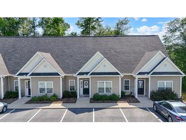 Charming one-story townhome with neutral siding and black trim, surrounded by lush landscaping and convenient parking at 116 Kingsbury Loop # C, Conway, SC 29526