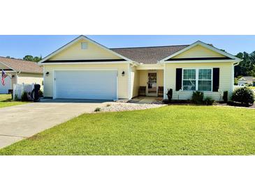 Charming single-story home featuring a manicured lawn, attached garage, and inviting front entrance at 1300 Ruddy Ct., Conway, SC 29527