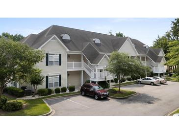Charming condo exterior with multiple levels, white stairs, and a well-maintained parking area at 134 Scotch Broom Dr. # K - 201, Little River, SC 29566