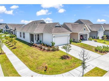 Charming single-story home with a well-manicured lawn and a two-car garage at 1360 Littleleaf Loop, North Myrtle Beach, SC 29582