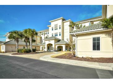 Inviting exterior of a multi-story building with lush landscaping and a welcoming entrance at 2180 Waterview Dr. # 1013, North Myrtle Beach, SC 29582