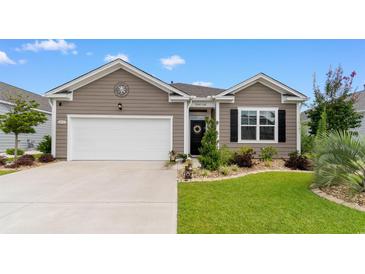 Charming home exterior with a well-manicured lawn and landscaping, highlighting its curb appeal and welcoming entrance at 2438 Polaris Path, Myrtle Beach, SC 29577