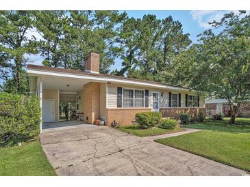 Charming single-story home featuring a brick facade, cozy carport, and a well-maintained front yard at 424 Villa Woods Dr., Myrtle Beach, SC 29579
