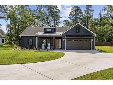 Charming single-story home featuring a well-manicured lawn and a spacious driveway at 4446 Boggy Rd., Conway, SC 29526