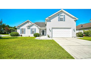 Charming two-story home with white siding, well-manicured lawn, and attached two-car garage at 501 Painted Duck Ct., Myrtle Beach, SC 29588