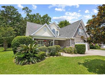 Charming two-story home featuring brick accents, a lush front yard, and manicured landscaping at 509 June Bug Ct., Myrtle Beach, SC 29588