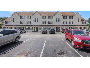 Condominium complex with ample parking spaces on a sunny day, offering convenient access for residents and visitors at 510 Fairwood Lakes Dr. # R-17, Myrtle Beach, SC 29588