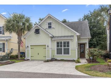 Charming light green single Gathering home with a well-manicured lawn and a one car garage at 6624 Lagoon Pl., Myrtle Beach, SC 29572