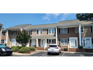 Charming townhome with a combination of tan siding and brick, a well-maintained lawn, and convenient parking at 6702 Jefferson Jefferson Pl. # F2, Myrtle Beach, SC 29572