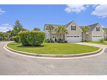 Charming home showcasing beautiful landscaping, manicured lawn, and an attached two-car garage at 800 Monarch Dr. # 49, Myrtle Beach, SC 29588