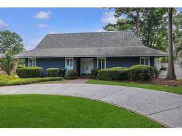 Charming one-story home featuring a circular driveway and well-manicured landscaping at 804 47Th Ave. N, Myrtle Beach, SC 29577