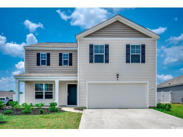 Charming two-story home with a well-manicured lawn and inviting curb appeal at 960 Corn Husk Loop, Conway, SC 29527
