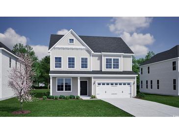 Charming two-story home with a manicured lawn, attached two-car garage, and neutral-toned siding and trim at 1076 Laconic Dr., Myrtle Beach, SC 29588