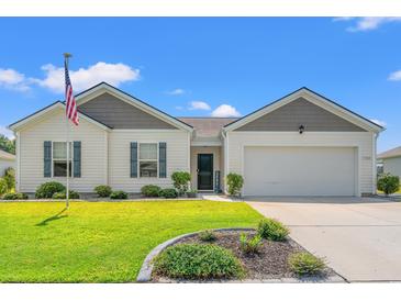 Charming one-story home featuring a well-manicured lawn and an attached two-car garage at 1108 Donald St., Conway, SC 29527