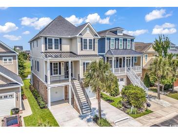 Stunning elevated home with a neutral color palette, manicured landscaping, and convenient garage access at 1112 Whispering Winds Dr., Myrtle Beach, SC 29579