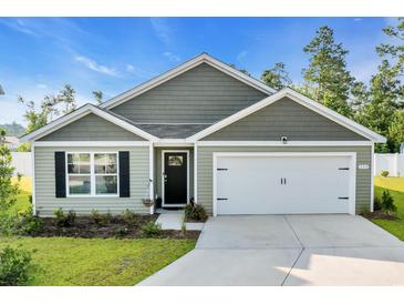 Charming single-Gathering home with an attached garage and manicured lawn at 113 Arbor Crest Ln., Tabor City, NC 28463