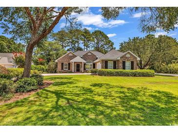 Charming single-story brick home with lush green lawn and mature trees in a desirable neighborhood at 1788 Club Circle, Pawleys Island, SC 29585