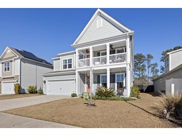 Charming two-story home boasts a double porch, well-maintained lawn, and inviting curb appeal at 1838 Zodiac Court, Myrtle Beach, SC 29577