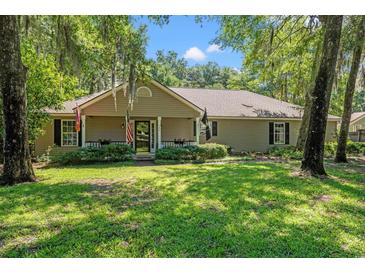 Charming single-story home with a well-manicured lawn and mature trees at 196 Weston Rd., Pawleys Island, SC 29585