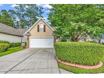 Charming home with a well-manicured lawn, mature trees, and a two-car garage at 2818 Sanctuary Blvd., Conway, SC 29526