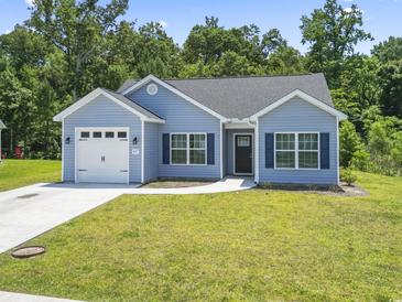 Charming single-story home with light blue siding, a well-manicured lawn, and an attached one-car garage at 437 Shallow Cove Dr., Conway, SC 29527