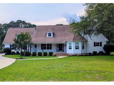 Charming single-story home featuring a well-manicured lawn, complemented by mature trees and meticulous landscaping at 4719 National Dr., Myrtle Beach, SC 29579
