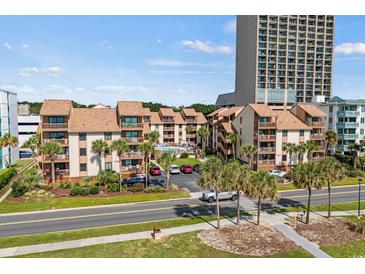 Beautiful condominium complex featuring well-maintained landscaping, a pool, and close proximity to the beach at 5515 N Ocean Blvd. N # 206, Myrtle Beach, SC 29577