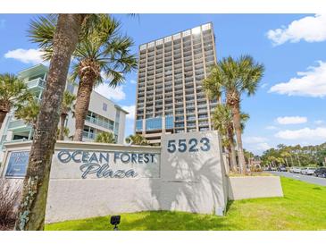 Exterior of the building with a view of the Ocean Forest Plaza sign, palm trees, and blue skies at 5523 N Ocean Blvd. # 2006, Myrtle Beach, SC 29577