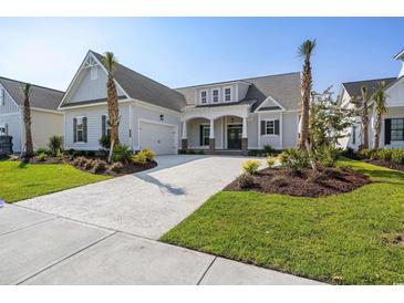 Beautiful single-story home featuring a well-manicured lawn, inviting entrance, and a spacious driveway at 6850 Belancino Blvd., Myrtle Beach, SC 29579