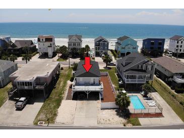 Aerial view of beach home with covered parking, deck, and ocean views at 710 S Waccamaw Dr., Garden City Beach, SC 29576