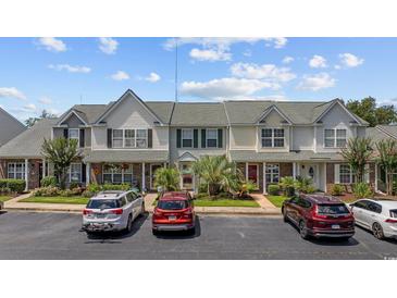 Inviting townhome with manicured landscaping, neutral siding, and convenient parking at 807 Wilshire Ln. # 807, Murrells Inlet, SC 29576